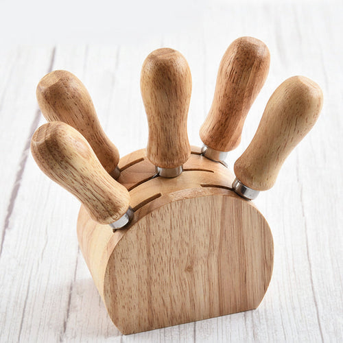 Stainless steel cheese knives displayed upright in a round rubberwood storage holder
