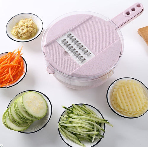 Pink 8-in-1 mandoline slicer displayed with sliced zucchini, shredded carrots, and grated vegetables